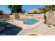 Backyard swimming pool with steps and lounge chair, surrounded by gravel and block wall at 14968 N 134Th Ln, Surprise, AZ 85379