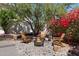Charming backyard retreat featuring a stone patio, Adirondack chairs, and a cozy fire pit perfect for relaxation at 15034 S 44Th Pl, Phoenix, AZ 85044