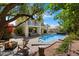 Lush backyard with a sparkling pool, fire pit, and comfortable seating, perfect for outdoor entertaining and relaxation at 15034 S 44Th Pl, Phoenix, AZ 85044