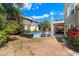 Spacious backyard with a sparkling pool, seating area, lush greenery, and a well-maintained lawn at 15034 S 44Th Pl, Phoenix, AZ 85044