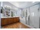 Well-lit bathroom with double sink vanity, soaking tub, and glass shower at 15034 S 44Th Pl, Phoenix, AZ 85044
