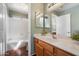 Bright bathroom with wood-look flooring, double vanity, and a shower-tub combo, inviting a refreshing and clean experience at 15034 S 44Th Pl, Phoenix, AZ 85044