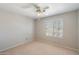 Inviting bedroom featuring neutral walls, plush carpeting, a ceiling fan, and a window with plantation shutters at 15034 S 44Th Pl, Phoenix, AZ 85044