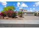 Charming two-story home featuring mature landscaping, a three-car garage, and a tile roof at 15034 S 44Th Pl, Phoenix, AZ 85044