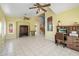 Open-concept living room with neutral tile, vintage furniture, and a decorative staircase at 15034 S 44Th Pl, Phoenix, AZ 85044