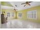 Spacious, sun-filled room with tile floors and multiple ceiling fans at 15034 S 44Th Pl, Phoenix, AZ 85044