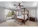 Comfortable main bedroom with canopy bed and balcony access at 15034 S 44Th Pl, Phoenix, AZ 85044