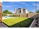 Large backyard featuring a sparkling pool, green lawn, and privacy fence, perfect for outdoor enjoyment at 1554 E Kings Ct, Gilbert, AZ 85234
