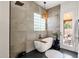 Modern bathroom with a freestanding tub, unique lighting, and access to the outdoor patio at 1554 E Kings Ct, Gilbert, AZ 85234