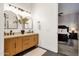 Bathroom featuring double sinks, stylish mirrors, and an open view to the bedroom at 1554 E Kings Ct, Gilbert, AZ 85234