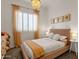 Charming bedroom featuring a decorative chandelier, shuttered window, and soft, inviting decor at 1554 E Kings Ct, Gilbert, AZ 85234