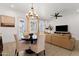 Open-concept dining area featuring a round table, comfortable chairs, and a view into the living room at 1554 E Kings Ct, Gilbert, AZ 85234