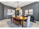 Inviting dining room with modern chandelier, artwork, and seamless flow to other areas at 1554 E Kings Ct, Gilbert, AZ 85234