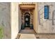 Inviting entryway showcasing an arched brick doorway with a decorative wrought iron gate and tiled roof at 1554 E Kings Ct, Gilbert, AZ 85234