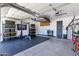 Spacious garage with ample storage, an exercise area, and a well-organized layout at 1554 E Kings Ct, Gilbert, AZ 85234