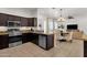 Modern kitchen features stainless steel appliances, dark cabinetry, and a cozy eat-in area at 1554 E Kings Ct, Gilbert, AZ 85234