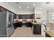 Well-equipped kitchen featuring stainless steel appliances, dark wood cabinets, and granite countertops at 1554 E Kings Ct, Gilbert, AZ 85234