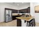 Modern kitchen with stainless steel appliances, granite countertops, and a breakfast bar with seating at 1554 E Kings Ct, Gilbert, AZ 85234