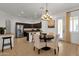 Open concept kitchen featuring granite countertops, stainless steel appliances, and a view into the dining area at 1554 E Kings Ct, Gilbert, AZ 85234