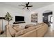 Comfortable living room with a large sectional sofa, modern decor, and a wall-mounted television at 1554 E Kings Ct, Gilbert, AZ 85234
