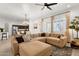 Open-concept living room featuring a large sectional sofa, recessed lighting, and a view into the adjacent kitchen at 1554 E Kings Ct, Gilbert, AZ 85234
