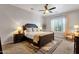 Serene bedroom with ceiling fan, neutral tones, and a cozy seating area by the window at 1554 E Kings Ct, Gilbert, AZ 85234