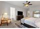 Relaxing bedroom showcases a ceiling fan, carpet, and a cozy chair with a lamp at 1554 E Kings Ct, Gilbert, AZ 85234