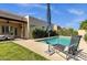 Relaxing backyard oasis with a sparkling pool, lounge chair, and a covered patio, ideal for enjoying outdoor living at 1554 E Kings Ct, Gilbert, AZ 85234