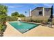 Sparkling in-ground pool featuring concrete surround and lush landscaping in a private backyard setting at 1554 E Kings Ct, Gilbert, AZ 85234