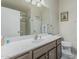 Bathroom featuring a wide countertop, vanity, a large mirror and modern design at 16675 W Taylor St, Goodyear, AZ 85338