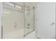 Bathroom featuring a shower with glass doors and a tub with modern tiling at 16675 W Taylor St, Goodyear, AZ 85338
