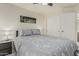 Well-lit bedroom with fan, sleek side tables, and closet at 16675 W Taylor St, Goodyear, AZ 85338