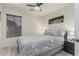 A comfortable bedroom with an overhead fan and natural light from the window at 16675 W Taylor St, Goodyear, AZ 85338