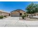 Charming single-story home showcasing a low maintenance front yard and an attached two-car garage at 16675 W Taylor St, Goodyear, AZ 85338