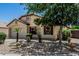 Charming single-story home highlighting mature trees in the front yard and an attached two-car garage at 16675 W Taylor St, Goodyear, AZ 85338