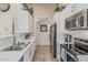 Contemporary kitchen featuring stainless appliances, white cabinets and countertops, with backsplash detail at 16675 W Taylor St, Goodyear, AZ 85338