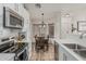 Bright kitchen with stainless steel appliances and adjacent dining area with decorative chandelier at 16675 W Taylor St, Goodyear, AZ 85338
