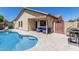 Relaxing backyard oasis featuring a pool, covered patio, and cozy outdoor seating at 16675 W Taylor St, Goodyear, AZ 85338