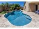 Beautiful backyard pool with mature landscaping and lounge chairs for relaxing at 16675 W Taylor St, Goodyear, AZ 85338