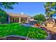 Well-maintained backyard featuring a custom pool, outdoor seating, and lush landscaping at 1681 S Karen Dr, Chandler, AZ 85286