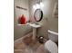 Charming powder room with pedestal sink, decorative niche and round mirror at 1681 S Karen Dr, Chandler, AZ 85286