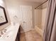 Bathroom featuring a single vanity, tiled floor, and a shower-tub combo with a curtain at 1681 S Karen Dr, Chandler, AZ 85286