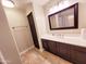 Bathroom featuring modern vanity with storage cabinets, tiled floor, and sleek design at 1681 S Karen Dr, Chandler, AZ 85286