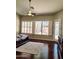 Bedroom featuring a ceiling fan, wood floors, and backyard views at 1681 S Karen Dr, Chandler, AZ 85286