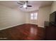 Spacious bedroom featuring a ceiling fan, window with shutters, and rich hardwood flooring at 1681 S Karen Dr, Chandler, AZ 85286