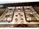 Close-up of a stainless steel cooktop with four burners, set into a granite countertop at 1681 S Karen Dr, Chandler, AZ 85286