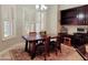Cozy dining area with natural light, plantation shutters and a wood table with seating at 1681 S Karen Dr, Chandler, AZ 85286