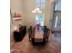 Elegant dining room with a chandelier, beautiful painting, and a table set for six, perfect for Gathering gatherings at 1681 S Karen Dr, Chandler, AZ 85286