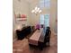 Dining room featuring a chandelier, plantation shutters and view to the living area at 1681 S Karen Dr, Chandler, AZ 85286