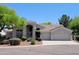 Charming single-story home with a desert landscape, three car garage and a covered front entry at 1681 S Karen Dr, Chandler, AZ 85286